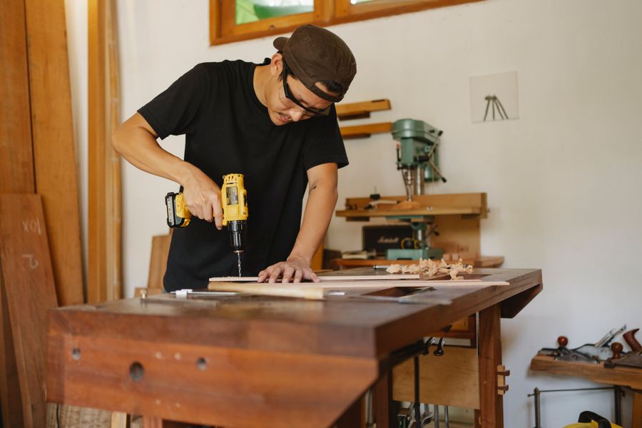Power tools work — worker using a power drill